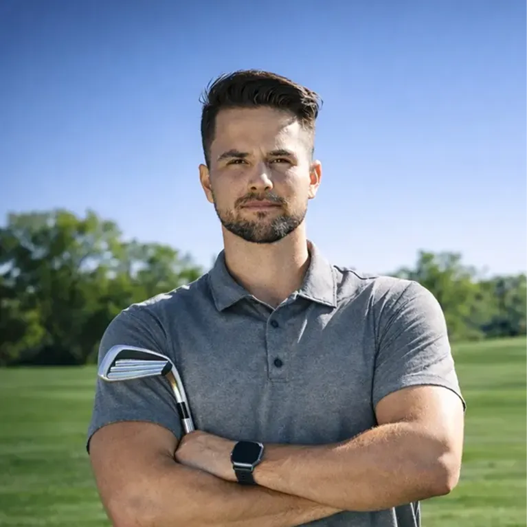 Man holding golf club outdoors