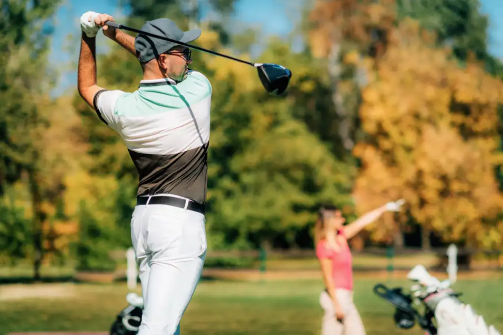 golf-couples-young-man-teeing-off-his-partner-fo-2026-03-10-04-01-32-utc