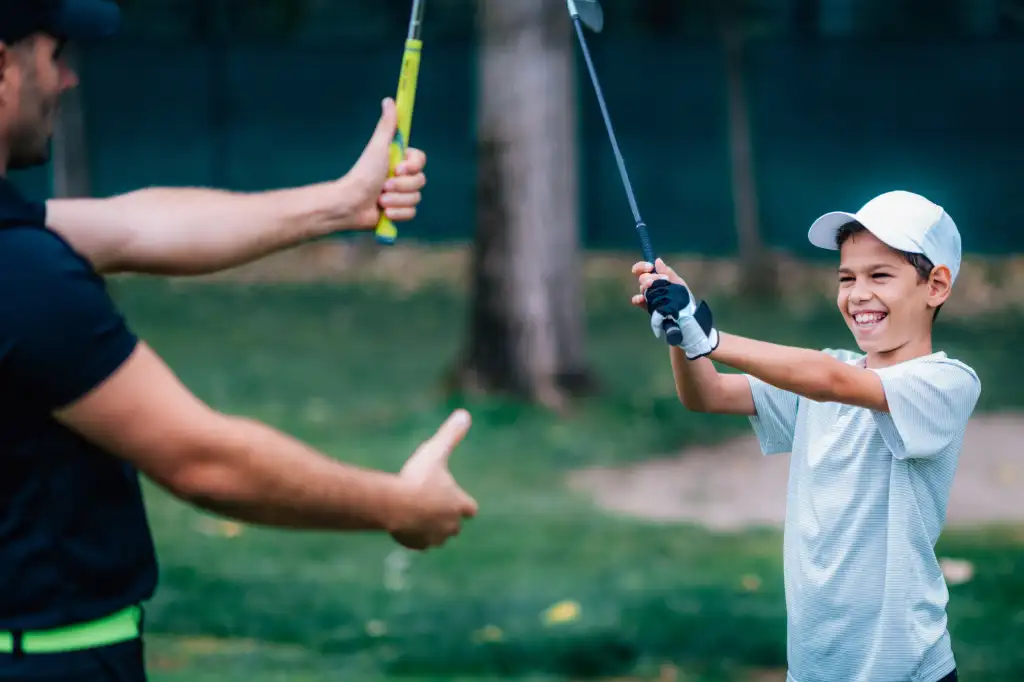golf-instructor-adjusting-young-boy-s-grip-2026-03-10-02-06-52-utc