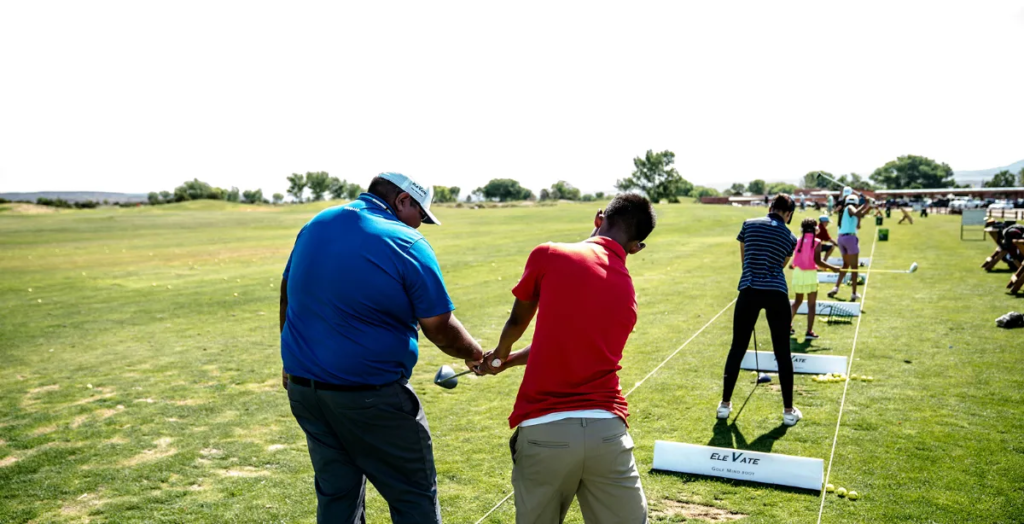 man teaching a kid to swing