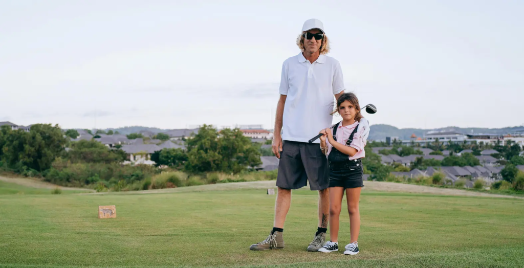 Man and girl on golf course.